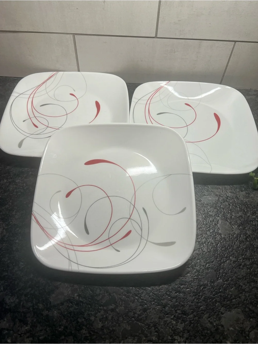 Corelle SPLENDOR White Square Dinner Plates with Red and Gray Swirl Design.